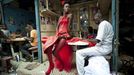 In this photo provided on Friday Feb. 10, 2012 by World Press Photo, the 2nd prize Arts and Entertainment Singles category of the 2012 World Press Photo contest by Vincent Boisot, France, Riva Press for Le Figaro Magazine, shows a model posing in front of tailor stalls in the center of Dakar, Senegal, July 9, 2011. She wears the creation of a designer, Yolande Mancini, participating in the 9th edition of Dakar Fashion Week.