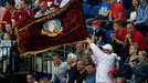 A supporter waves a flag with Vladimir Ilici Lenin's portrait during the men's ice hockey World Championship quarter-final game between Russia and France at Minsk Arena i