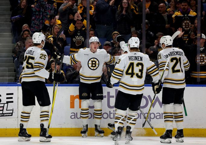 Dec 27, 2023; Buffalo, New York, USA;  Boston Bruins defenseman Mason Lohrei (6) celebrates his goal with teammates during the first period against the Buffalo Sabres at