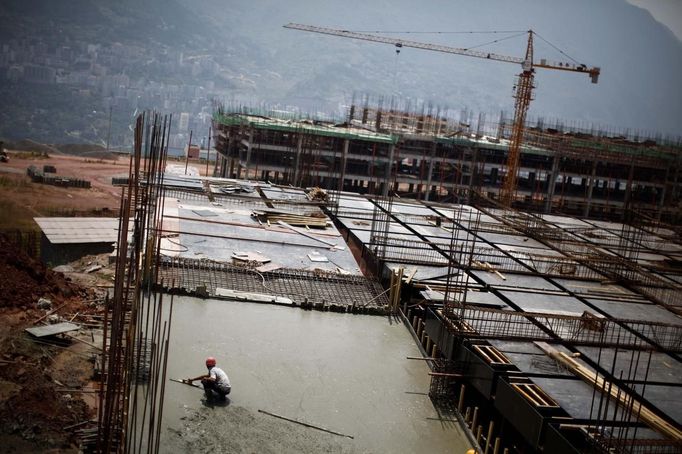 A labourer works at a construction site to raise houses for people who will be relocated in Badong, on the banks of the Yangtze River, 100km (62 miles) from the Three Gorges dam in Hubei province in this August 7, 2012 file photo. China relocated 1.3 million people during the 17 years it took to complete the Three Gorges dam. Even after finishing the $59 billion project last month, the threat of landslides along the dam's banks will force tens of thousands to move again. It's a reminder of the social and environmental challenges that have dogged the world's largest hydroelectric project. While there has been little protest among residents who will be relocated a second time, the environmental fallout over other big investments in China has become a hot-button issue ahead of a leadership transition this year. Picture taken on August 7, 2012. To match story CHINA-THREEGORGES/ REUTERS/Carlos Barria/Files (CHINA - Tags: POLITICS ENVIRONMENT BUSINESS ENERGY EMPLOYMENT) Published: Srp. 22, 2012, 8:30 odp.