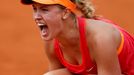 Eugenie Bouchard of Canada reacts after winning her women's quarter-final match against Carla Suarez Navarro of Spain at the French Open Tennis tournament at the Roland G