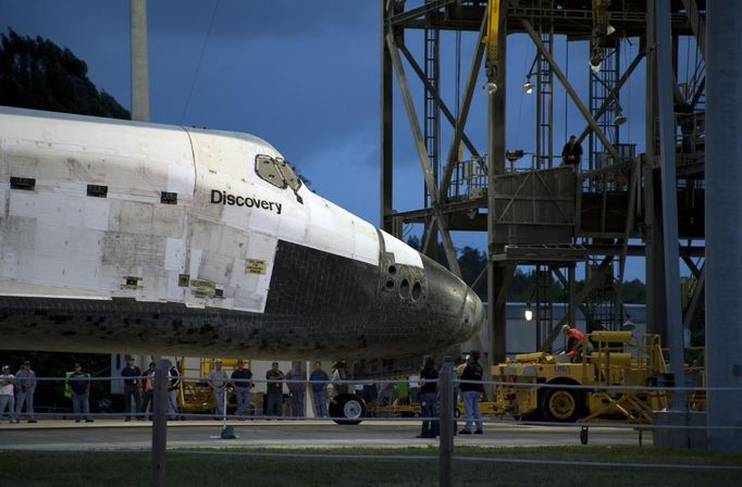 The space shuttle Discovery is being towed for the last time out of the Vehicle Assembly Building to the Mate Demate Facility at Kennedy Space Center