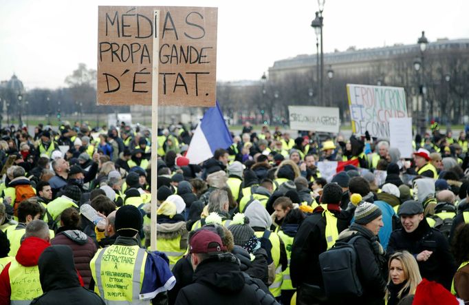 Protesters wearing yellow vests take part in a demonstration by the "yellow vests" movement, in Paris, France, January 19, 2019. The sign reads "Media State Propaganda".