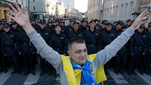 Muž s ukrajinskou vlajkou na protiválečných protestech v Moskvě.
