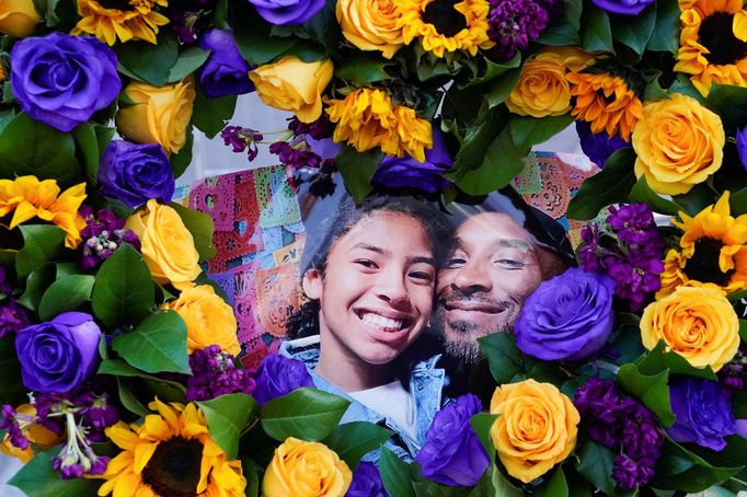 Flowers and photos of Kobe Bryant and his daughter Gianna "Gigi" are placed near the Staples Center to pay tribute after a helicopter crash killed the retired basketball