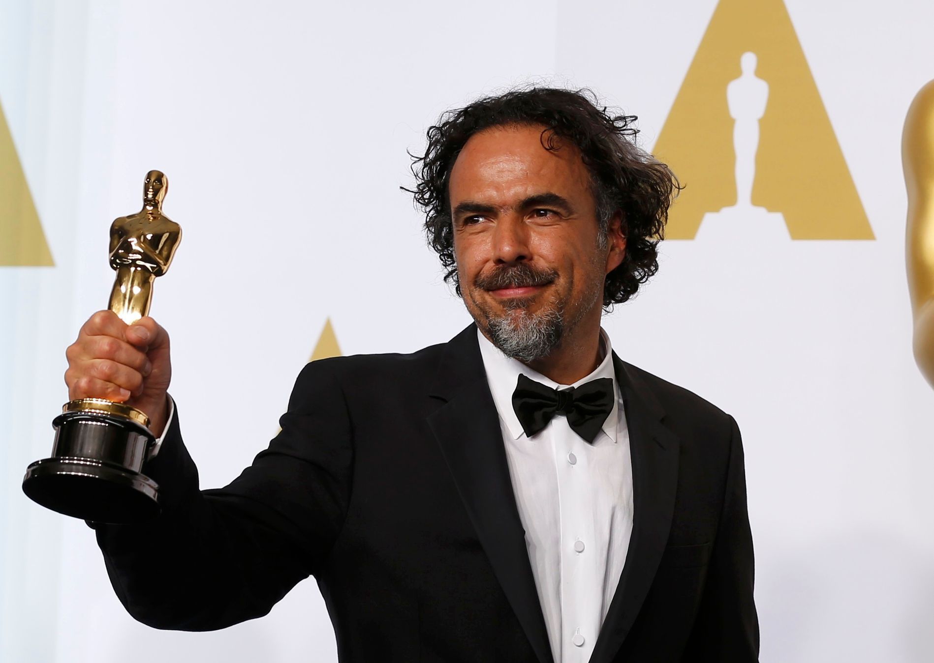 Director Alejandro G. Inarritu poses with the Oscar for best original screenplay for &quot;Birdman&quot; at the 87th Academy Awards in Hollywood