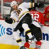 Bruins' Thornton checks Blackhawks' Rozsival during of their