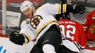 Boston Bruins' Shawn Thornton (L) checks Chicago Blackhawks' Michal Rozsival during the first period in Game 2 of their NHL Stanley Cup Finals hockey series in Chicago, I