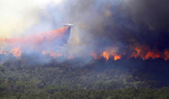 An aircraft drops fire retardant over the Wood Hollow fire, north of Fairview, Utah, June 26, 2012. More than 500 structures have been threatened by the Wood Hollow fire, forcing up to 1,500 people from homes. REUTERS/George Frey (UNITED STATES - Tags: ENVIRONMENT DISASTER) Published: Čer. 26, 2012, 9:29 odp.