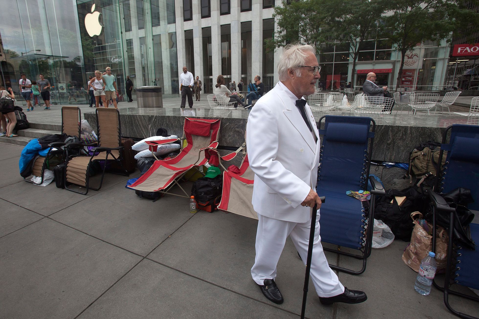 A man, dressed up as Colonel Sanders, walks outside the Apple Store in advance of an Apple special event, in the Manhattan borough of New York