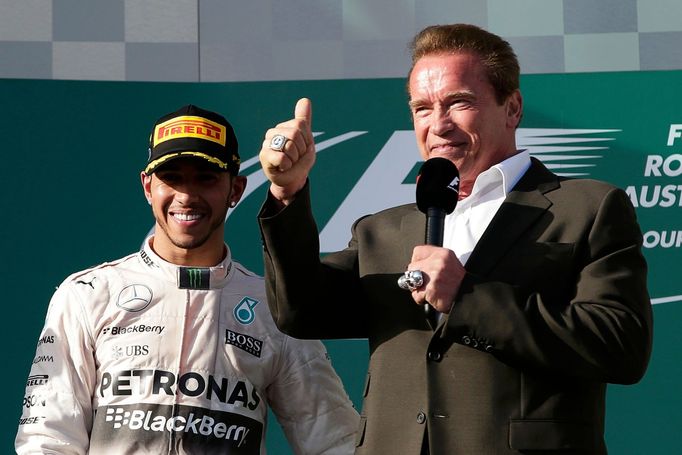 Race winner Mercedes Formula One driver Lewis Hamilton of Britain (L) stands next to actor Arnold Schwarzenegger during the podium ceremony of the Australian F1 Grand Pri