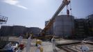 Workers wearing protective suits and masks are seen near tanks of radiation contaminated water at Tokyo Electric Power Company's (TEPCO) tsunami-crippled Fukushima Daiichi nuclear power plant in Fukushima prefecture March 6, 2013, ahead of the second-year of anniversary of the the March 11, 2011 tsunami and earthquake. REUTERS/Issei Kato (JAPAN - Tags: DISASTER ANNIVERSARY) Published: Bře. 6, 2013, 11:26 dop.