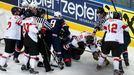 Players of the U.S. and Switzerland fight during the first period of their men's ice hockey World Championship group B game at Minsk Arena in Minsk May 10, 2014. REUTERS/