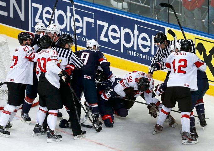 Players of the U.S. and Switzerland fight during the first period of their men's ice hockey World Championship group B game at Minsk Arena in Minsk May 10, 2014. REUTERS/