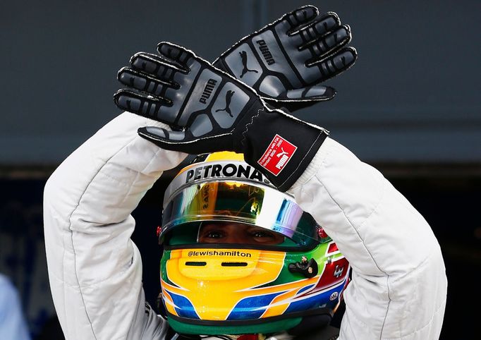 Mercedes Formula One driver Lewis Hamilton of Britain celebrates taking pole position for the final during the qualifying session for the British Grand Prix at the Silver