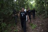 Členové forenzních jednotek vynesli z džungle ostatky těl v igelitových pytlích.