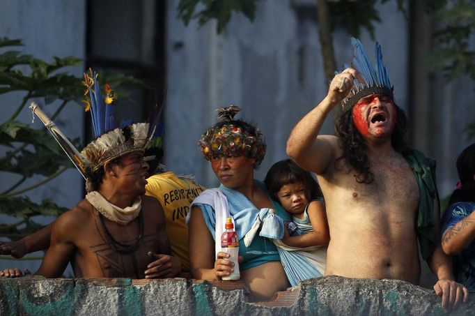 Members of the native Indian community living at the Brazilian Indian Museum wait on a wall inside the museum in Rio de Janeiro, March 22, 2013. Brazilian military police took position early morning outside the abandoned museum, where the community of around 30 native Indians have been living in since 2006. The community was ordered to leave the museum in 72 hours by court officials since last week, local media reported. Most of the Indians later left the museum after making a deal with the authorities. REUTERS/Pilar Olivares(BRAZIL - Tags: POLITICS CIVIL UNREST SOCIETY) Published: Bře. 22, 2013, 6:59 odp.