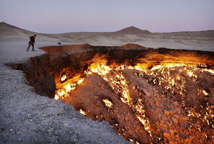 Darvaza 'Gates Of Hell' gas crater in Karakum Desert, Turkmenistan - 21 Jul 2012 2012-07-21 00:00:00 Mandatory Credit: Photo by Amos Chapple / Rex Features (1843563b) The Gates Of Hell It's known by locals as the 'gates of hell' and after a glimpse of the Darvaza gas crater it isn't difficult to see why. Located in Turkmenistan's Karakum Desert, the eerie cavern has been on fire for more than 40 years. It was discovered in 1971 by Soviet geologists when the ground beneath their drilling rig suddenly collapsed, leaving a large hole with a diameter of 70 metres (230 ft). As the huge crater was filled with potentially poisonous natural gas the decision was made to set it alight. Scientists expected it to burn itself out within a few days, but fast forward several decades and, amazingly, the fire is still as fierce as ever. At night the orange glow it produces can be seen for miles around and the heat attracts animals and insects to huddle close by. Meanwhile, when the wind gust across the crater it turns scaldingly hot - being likened to the 'opening of an enormous oven door'. MUST CREDIT PHOTOS BY: Amos Chapple / Rex Features For more information visit http://www.rexfeatures.com/stacklink/IUSRWMDCZ