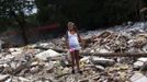 Erica Escudero recovers her little sister's shoes from the rubble of her grandparents' home at the Spanish gypsy settlement of Puerta de Hierro, in the outskirts of Madrid July 25, 2012. Fifty-four families have been living in Puerta de Hierro, on the banks of the Manzanares river for over 50 years. Since the summer of 2010, the community has been subject to evictions on the grounds that the dwellings are illegal. Families whose houses have been demolished, move in with relatives whose houses still remain while the debris keeps piling up around them as more demolitions take place. Picture taken July 25, 2012. REUTERS/Susana Vera (SPAIN - Tags: SOCIETY) ATTENTION EDITORS - PICTURE 23 OF 31 FOR PACKAGE 'GYPSY SITE DEMOLISHED' SEARCH 'GYPSY SITE' FOR ALL IMAGES Published: Lis. 5, 2012, 4:12 odp.