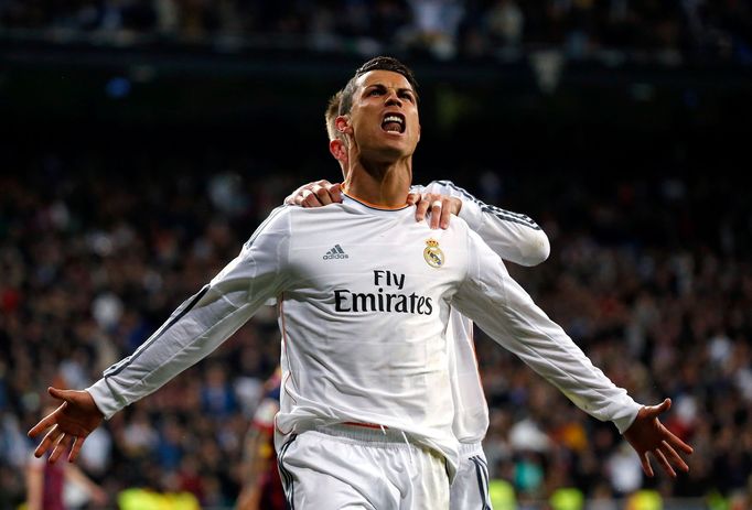 Real Madrid's Ronaldo and Ramos celebrate a goal against Barcelona during La Liga's second 'Clasico' soccer match of the season in Madrid