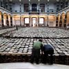 Assistants work on installation made of wooden stools by Chinese artist Ai Weiwei as part of exhibition 'Evidence'  at Martin-Gropius Bau in Berlin