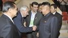 th Korean leader Kim shakes hands with unidentified officials of the International Weightlifting Federation and the Asian Weightlifting Federation during the 2013 Asian C