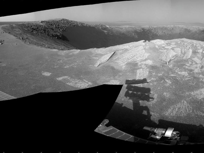 'Santa Maria' Crater in 360-Degree View, Sol 2451 A football-field-size crater, informally named "Santa Maria," dominates the scene in this 360-degree view from NASA's Mars Exploration Rover Opportunity. Following a 25-meter (82-foot) drive on the 2,451st Martian day, or sol, of the rover's work on Mars (Dec. 16, 2010), Opportunity used its navigation camera to take the frames combined into this mosaic. South is at the center. North is at both ends. The view is presented as a cylindrical projection. NASA's Jet Propulsion Laboratory, a division of the California Institute of Technology in Pasadena, manages the Mars Exploration Rover Project for the NASA Science Mission Directorate, Washington. Image Credit: NASA/JPL-Caltech