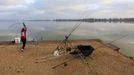 Dejan Savic of Serbia casts his fishing line during the 14th Carpfishing World Championship in Corbu village, 310 km (192 miles) east of Bucharest, September 29, 2012. REUTERS/Radu Sigheti (ROMANIA - Tags: SOCIETY) Published: Zář. 29, 2012, 4:28 odp.