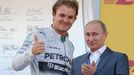 Russian President Vladimir Putin applaudes Mercedes Formula One driver Nico Rosberg of Germany after the first Russian Grand Prix in Sochi October 12, 2014. REUTERS/Laszl