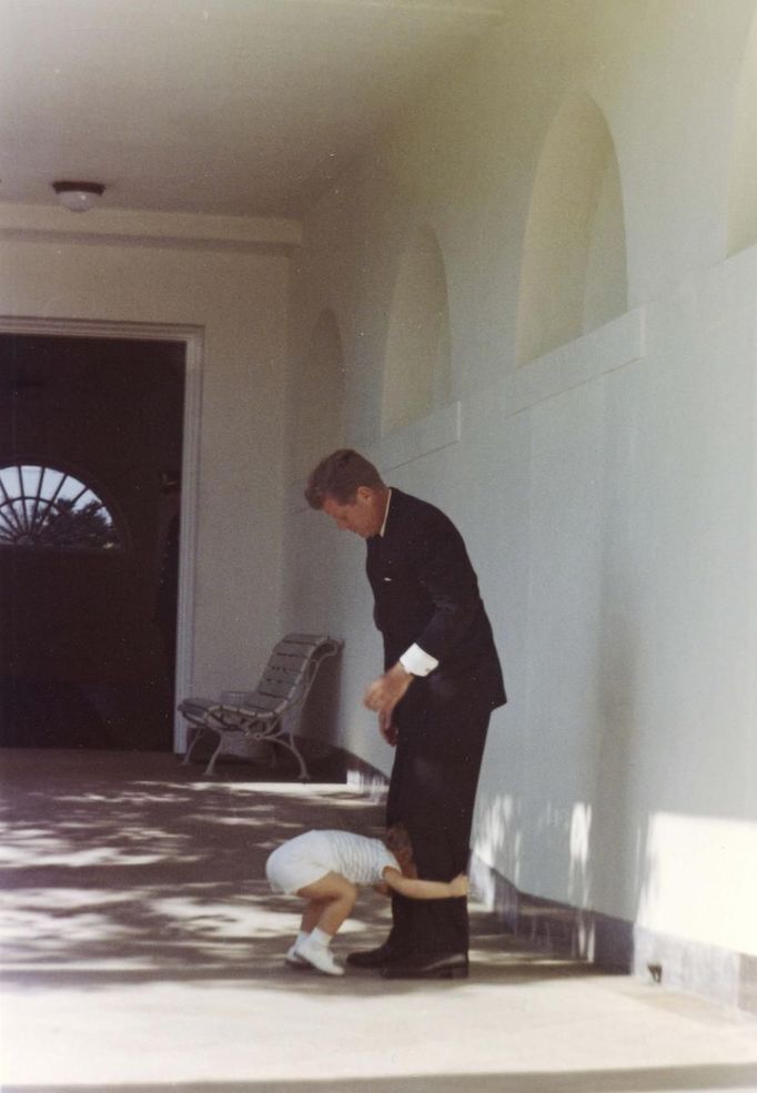 Former United States President John F. Kennedy walks with his son John F. Kennedy Jr. down the White House colonnade in Washington, in this handout image taken on October 10, 1963.