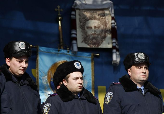 Police officers from Lviv who have arrived to join anti-government protesters appear on a stage in Independence Square in Kiev February 21, 2014.