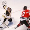 Bruins goalie Rask makes a save on Blackhawks' Toews during