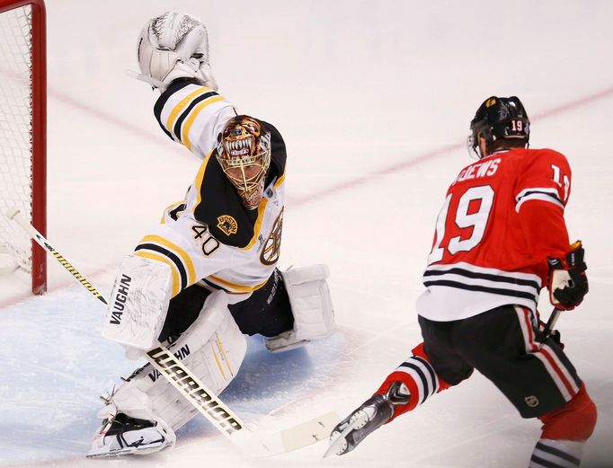 Boston Bruins goalie Tuukka Rask makes a save on Chicago Blackhawks' Jonathan Toews during the first period in Game 2 of their NHL Stanley Cup Finals hockey series in Chi