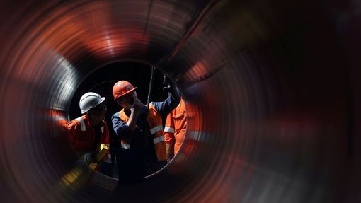 FILE PHOTO: Workers seen through a pipe at the construction site of the Nord Stream 2 gas pipeline, near the town of Kingisepp, Leningrad region, Russia, June 5, 2019. RE