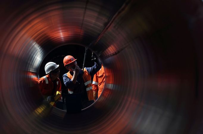 FILE PHOTO: Workers seen through a pipe at the construction site of the Nord Stream 2 gas pipeline, near the town of Kingisepp, Leningrad region, Russia, June 5, 2019. RE