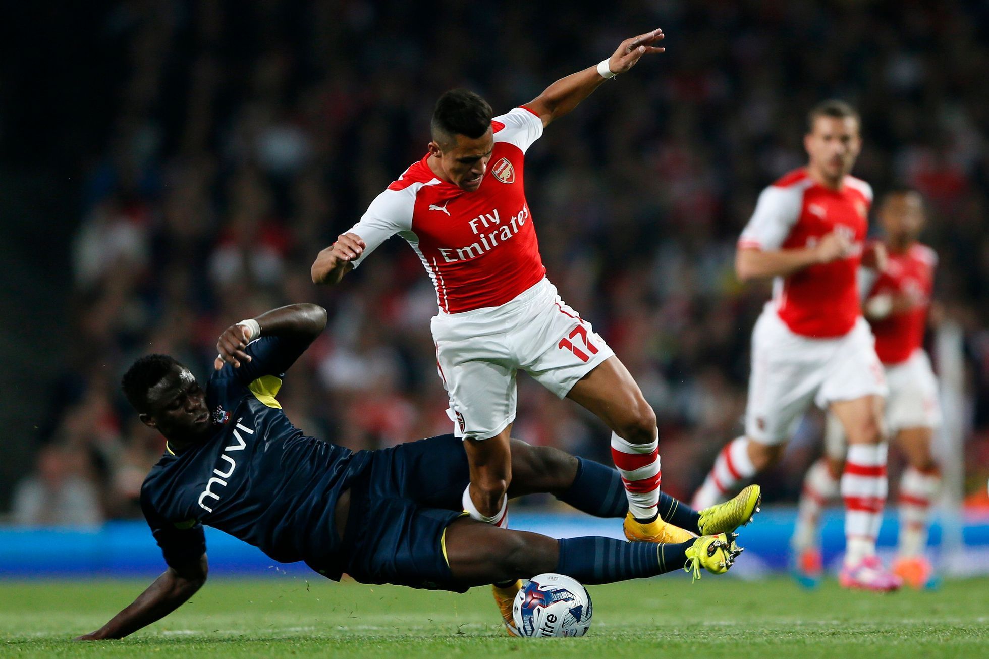 Arsenal's Sanchez fights for the ball with Southampton's Wanyama during their English League Cup soccer match at the Emirates stadium in London