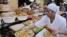 A vendor sells traditional cakes of fried honey and flour pastries to customers ahead of Ramadan in the medina of the Moroccan city of Rabat July 8, 2013. Ramadan, the Muslim fasting month, begins in Morocco on July 10 as each state determines when the fast should begin. Muslims around the world abstain from eating, drinking and sexual relations from sunrise to sunset during Ramadan, the holiest month in the Islamic calendar. REUTERS/Stringer (MOROCCO - Tags: FOOD SOCIETY RELIGION) Published: Čec. 8, 2013, 11:04 odp.