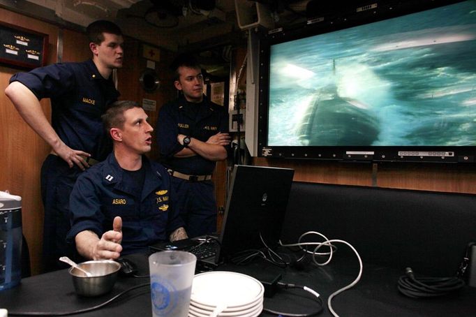 April 24, 2011 - Cape Canaveral, Florida, U.S. - -- Cape Canaveral, Fla. -- Lieutenant James Asaro, sitting, with other submariners watch a video screen in the wardroom aboard the USS Annapolis (SSN 760), a S6G nuclear reactor powered fast attack submarine, as it submerges while sailing from Cape Canaveral on Sunday. The USS Annapolis measures 362 ft. in length and 33 ft. at the beam, a diving depth of over 400 ft., 27+ mph, 12 vertical launch missile tubes, 4 torpedo tubes, and a crew of 130 enlisted submariners. The submarine was commissioned April 11, 1992 with its homeport in Groton, Connecticut. USS Annapolis sailed to the 21st Anniversary of Fleet Week at Port Everglades, Fort Lauderdale. (Credit Image: © Gary Coronado/The Palm Beach Post) ( automatický překlad do češtiny )