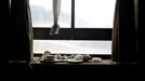 Light bulbs, bowls and plates lie on a windowsill at the abandoned Alps Ski Resort