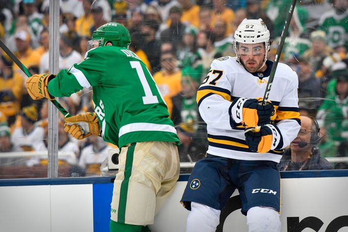 Jan 1, 2020; Dallas, Texas, USA; Dallas Stars center Jason Dickinson (18) checks Nashville Predators defenseman Dante Fabbro (57) during the 2020 Winter Classic hockey ga