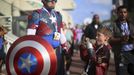 Shawn Richter shows his Captain America costume while his son Gavin looks on during the 2015 Comic-Con International in San Diego