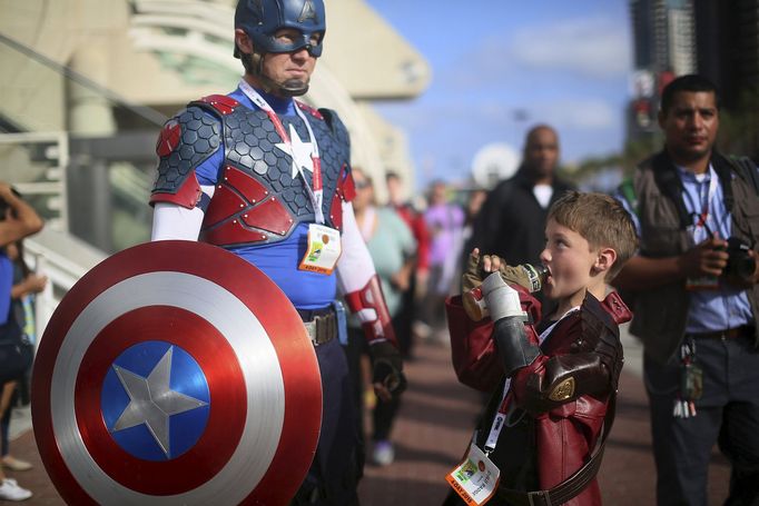 Shawn Richter shows his Captain America costume while his son Gavin looks on during the 2015 Comic-Con International in San Diego