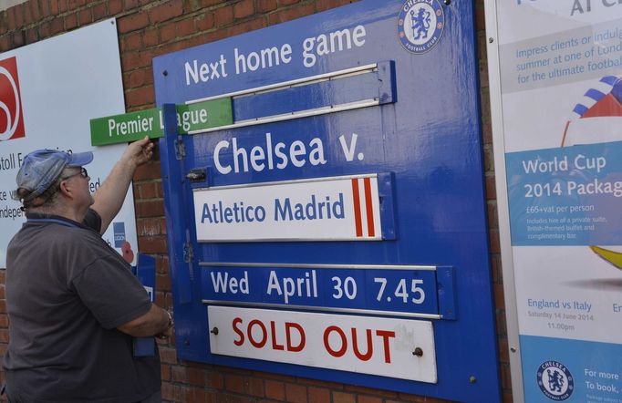 A Chelsea stadium worker changes the wooden fixture board to their next match following tonights Champion's League semi-final second leg soccer match against Atletico Mad