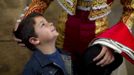 A boy looks at Spanish matador Fernandez before the start of a bullfight in Seville