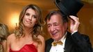 Italian actress Canalis poses in a dress by British designer Westwood with her host Austrian businessman Lugner ahead of the Opera Ball in Vienna