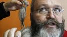 Elmar Weisser of Germany, 48, is helped by his wife as he gets ready to participate in the 2012 European Beard and Moustache Championships in Wittersdorf near Mulhouse, Eastern France, September 22, 2012. More than a hundred participants competed in the first European Beard and Moustache Championships organized in France. REUTERS/Vincent Kessler (FRANCE - Tags: SOCIETY TPX IMAGES OF THE DAY) Published: Zář. 22, 2012, 7:26 odp.