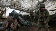 FILE PHOTO: Ukrainian servicemen fire a self-propelled howitzer towards Russian troops near the frontline town of Pokrovsk