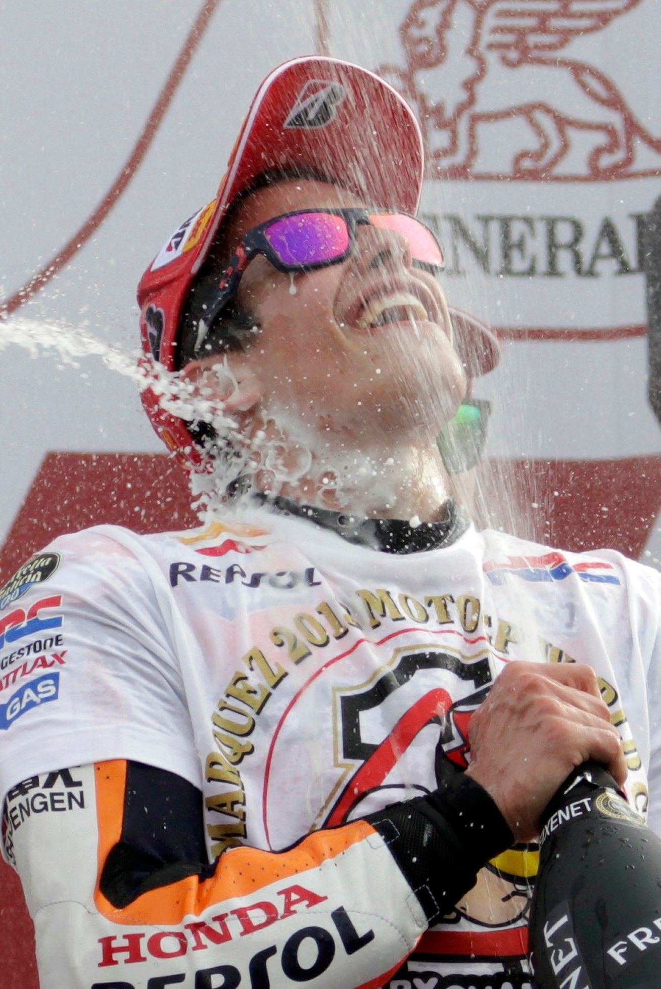 Honda MotoGP rider Spanish Marquez celebrates on podium after becoming the youngest MotoGP world champion at the end of the Valencia Motorcycle Grand Pri in Cheste