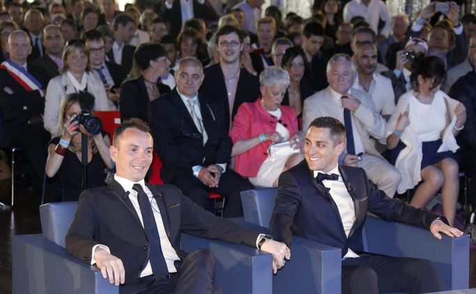 Vincent Aubin (L) and Bruno Boileau (R) hold hands at their wedding ceremony at the city hall in Montpellier, May 29, 2013. The two men are the first same-sex couple to marry in France under a reform which has stoked some of the ugliest protests in the country in decades. The law, backed by most French and feted by gay and lesbians as it came into force this month, makes France the 14th country to allow same-sex marriage despite heated street protests by conservatives, Catholics and extreme-right groups. REUTERS/Jean-Paul Pelissier (FRANCE - Tags: SOCIETY POLITICS TPX IMAGES OF THE DAY)