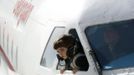 A child leans from the cockpit window of a plane at a kindergarten in the town of Rustavi some 25 km (15 miles) south of Tbilisi, October 31, 2012. The fully functional Soviet-era Yakovlev Yak-40 plane has been installed in the kindergarten courtyard and refurbished as a children's playground. REUTERS/David Mdzinarishvili (GEORGIA - Tags: EDUCATION SOCIETY TPX IMAGES OF THE DAY) Published: Říj. 31, 2012, 11:18 dop.